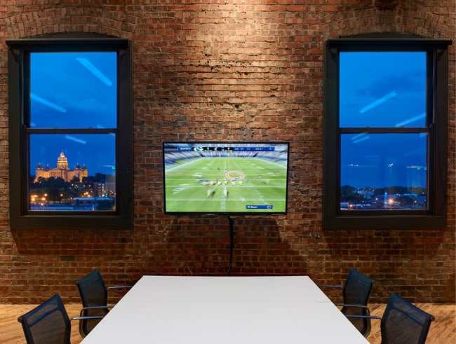 a conference with a television on the wall