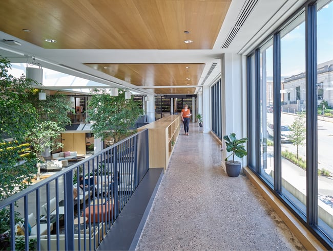 woman walking along the second floor of the Stanley Center, overlooking the first floor