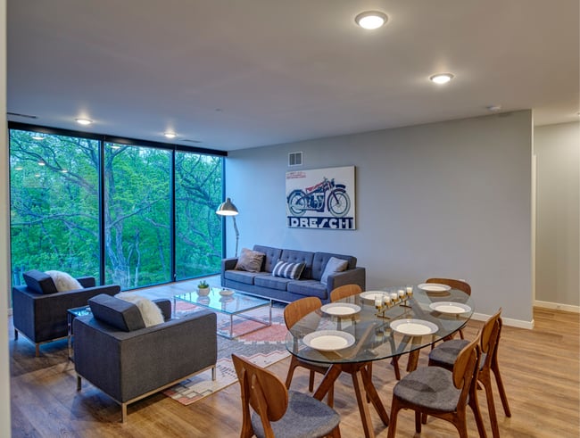 a living room in a multifamily unit with floor-to-ceiling windows
