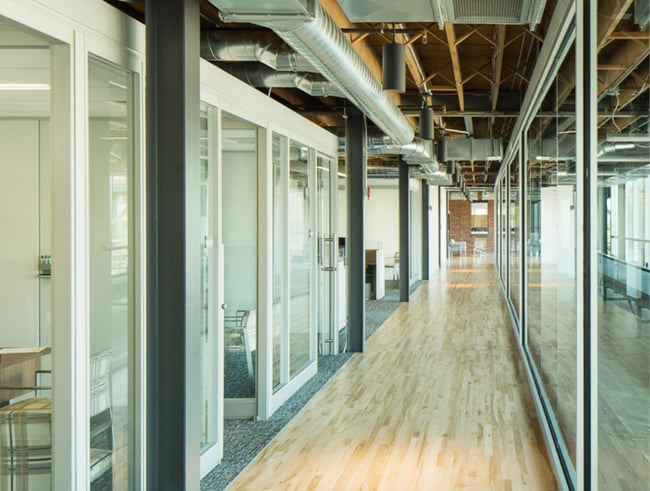 an office with wood floors and carpet