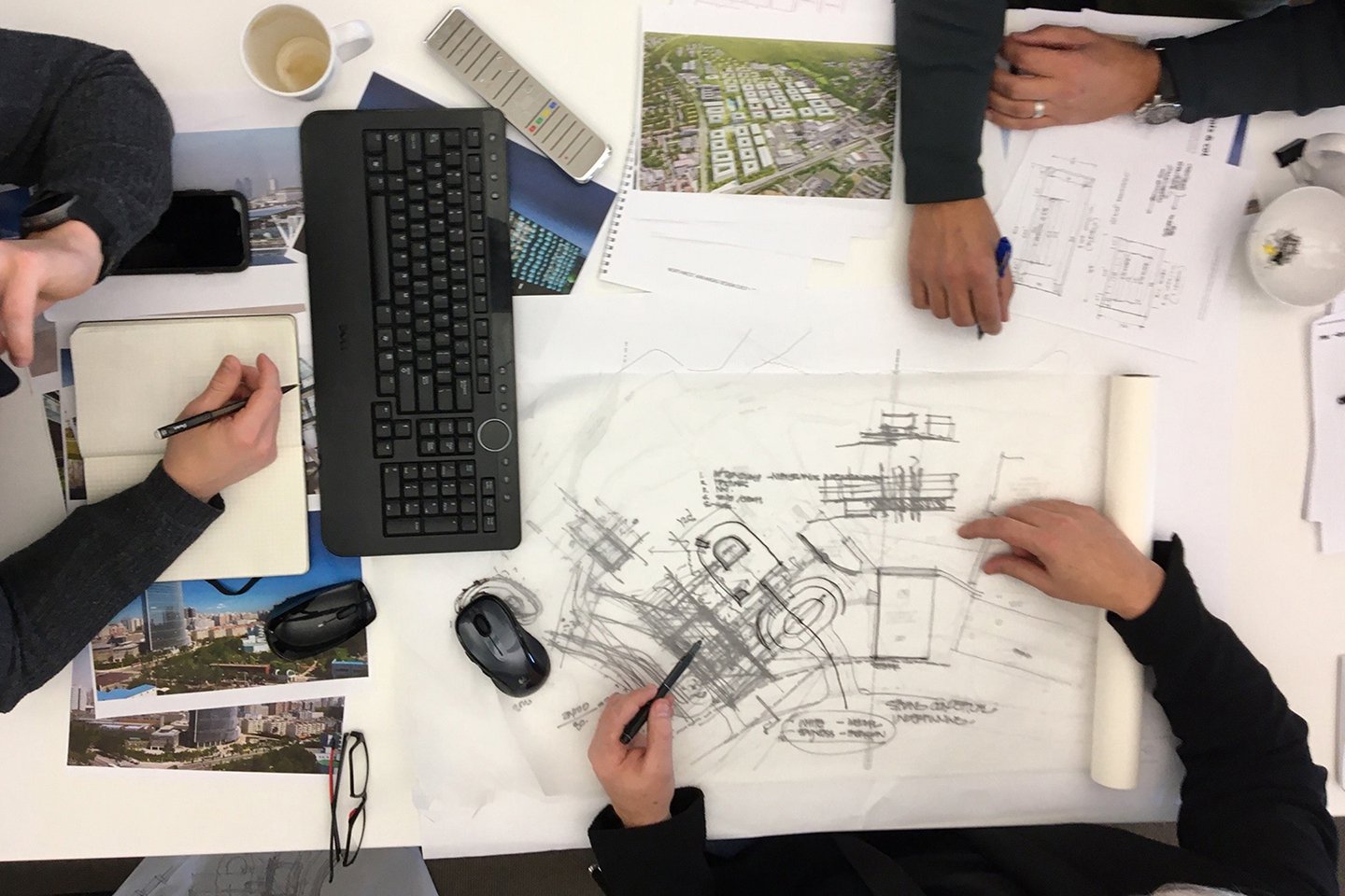 architects sketching at a drafting table 
