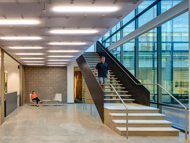 employee using the stairs in an office